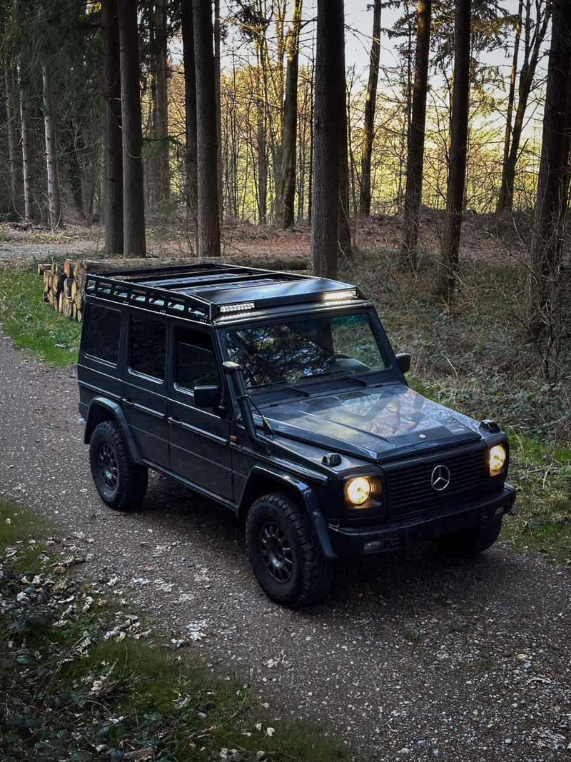 Dark G-Class with Walger Works roof rack, 3/4 view from above